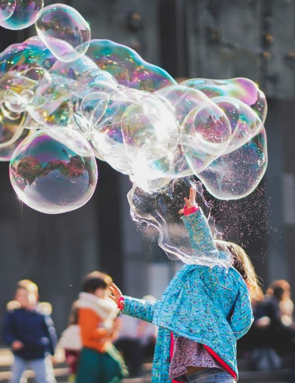 child popping large bubble